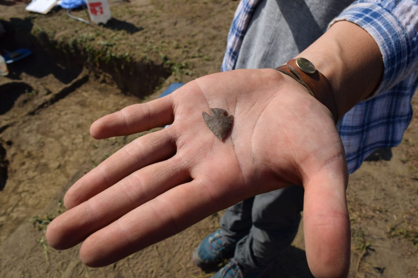 An arrowhead being held in an open palm