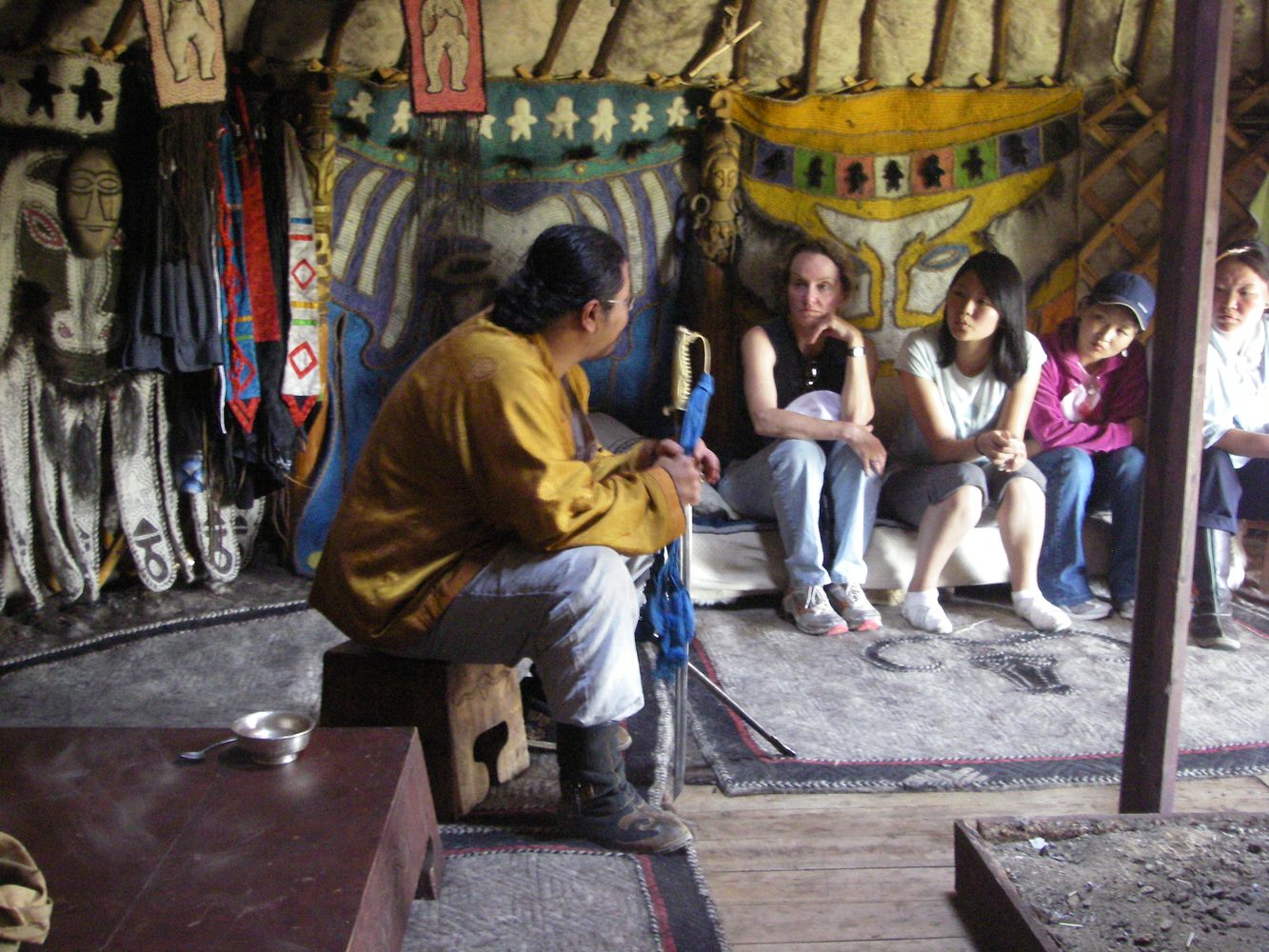 Students sitting and listening to locals of another culture