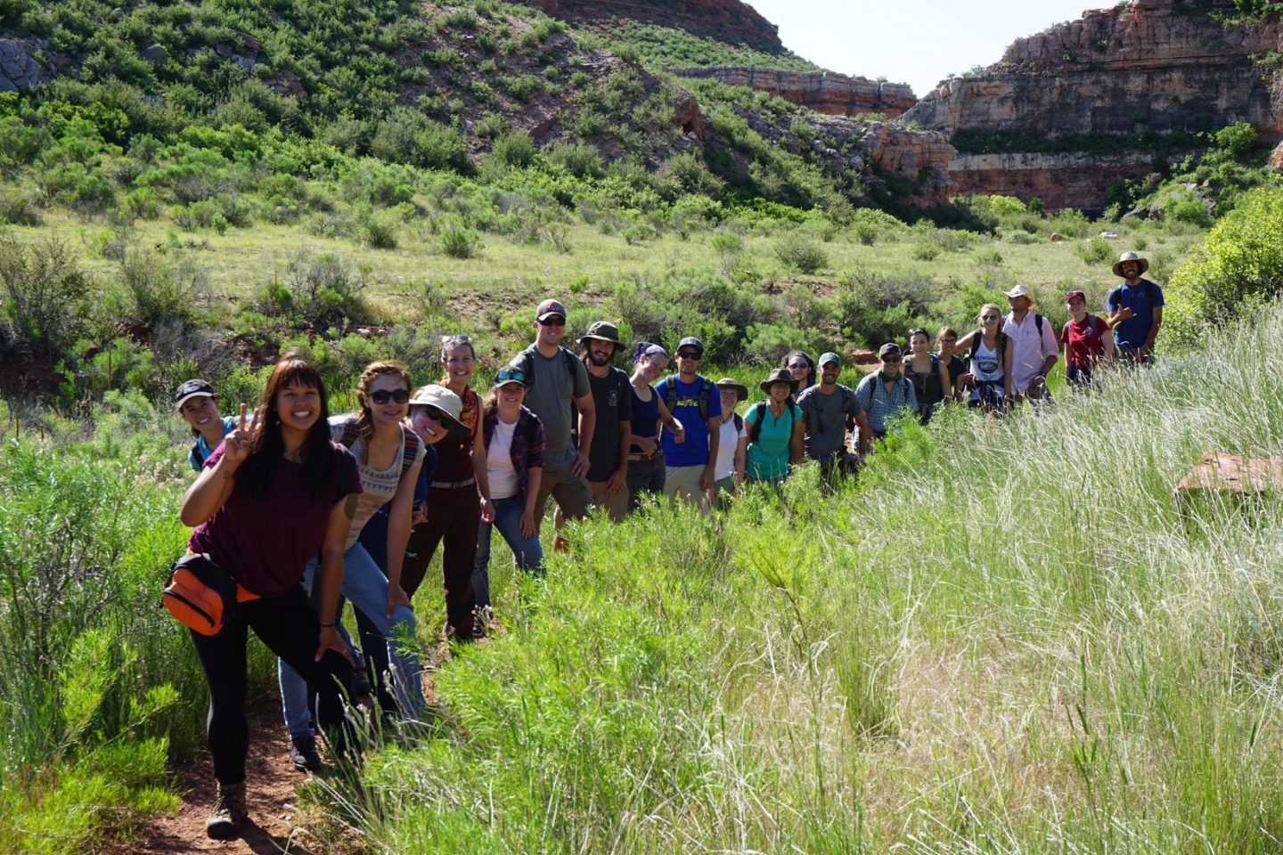Anthropology students lined up on a trail outside