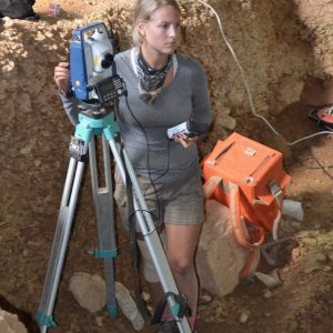 Grace Ellis, Anthropology and Geography PhD candidate, works with the total station, optical surveying instrument, at Lapa do Picareiro, Portugal 