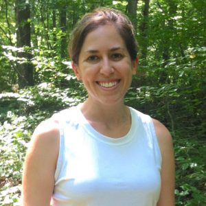 Professor headshot photo, in front of forest