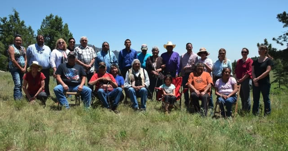 Group standign outdoors for posed photo during ceremony