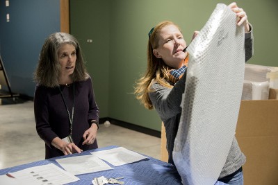 Museum Director Linny Frickman and and Collections Manager Suzanne Hale check off inventory as works arrive
