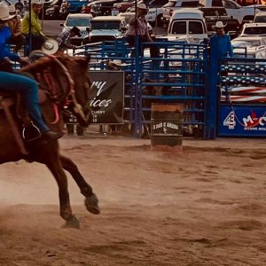 A woman barrel racing.