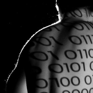 Figure with ones and zeros projected onto bare back.