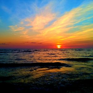 sunset over the ocean with many colors