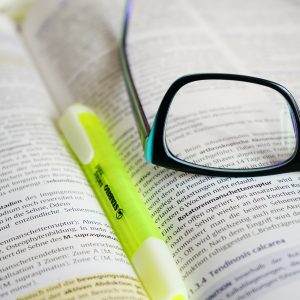 Glasses and highlighter resting on book