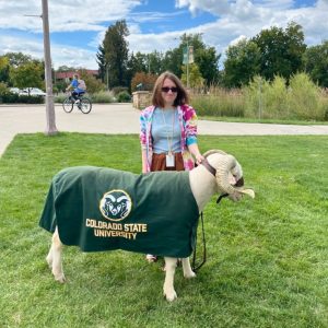 Anna Skarupa stands next to Cam the Ram on CSU camps.