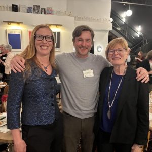 Julia Schleck, Dan Beachy-Quick, and Louann Reid stand and smile together at a Great Conversations event.