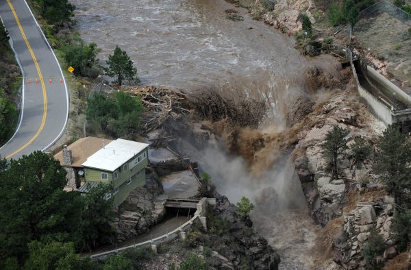 The Big Thompson River thunders through the east edge of the Big Thompson Canyon creating a large waterfall Friday September 13, 2013.The flood damaged sections of Highway 34, at the left.