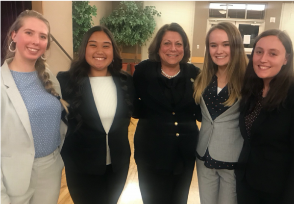 Simon with other interns at a town hall