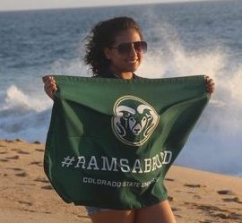 Girl holding Rams Flag on the beach