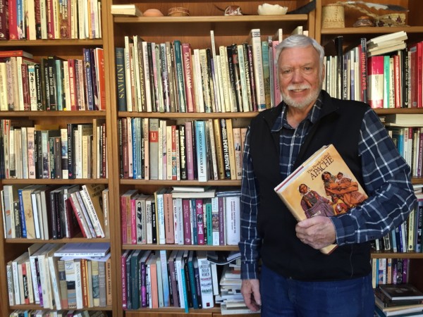 A photo of Peter Jacobs with his book collection.
