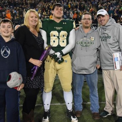 CSU defensive lineman Justin Hansen (68) is joined by, from left, his younger brother Logan, mother Kara, father Thomas and coach Mike Bobo at Hughes Stadium on Senior Night. (Photo: Don Reichert/CSU Athletics)