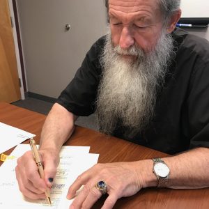 Don Williette signing donation letter