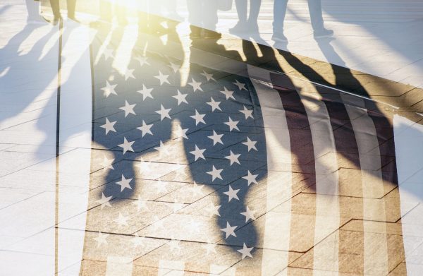Shadows of People in a street and Flag of The USA as Background