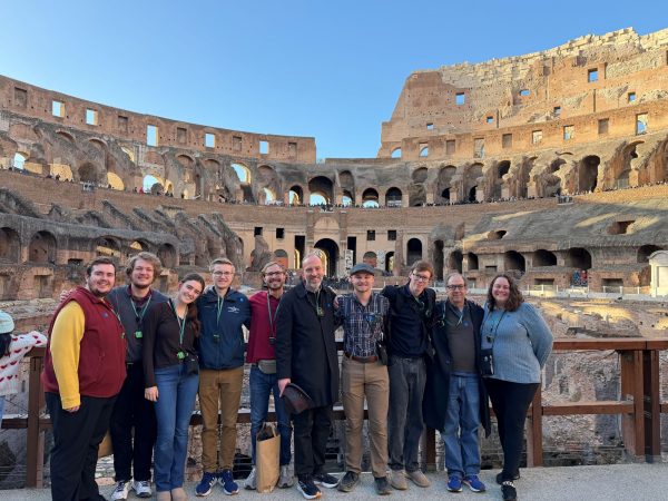 Joel Bacon and his students posing at the Colosseum in Rome