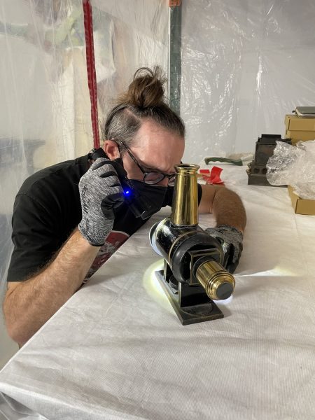 Jerry Smith inspects an object at the Lucas Museum's storage facility