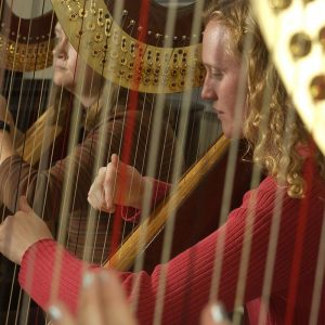 Pictured Joy Zartman playing Harp