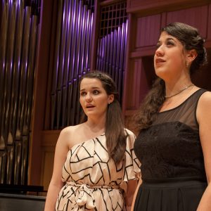 Two voice students pictured singing