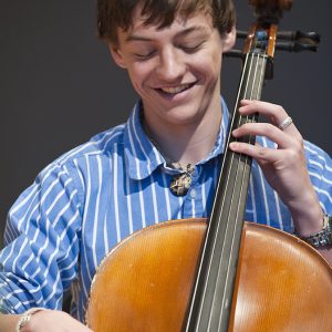 A high school student plays the cello