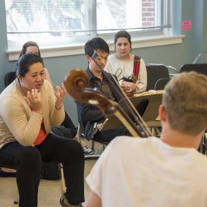 String faculty pictured working with students