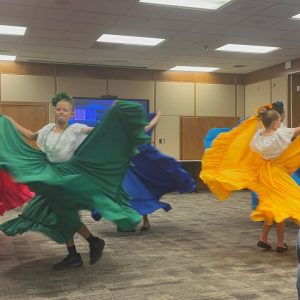 Students in bright costumes dance to the music of Irish Elementary Mariachi Jaguares y Flor Antigua