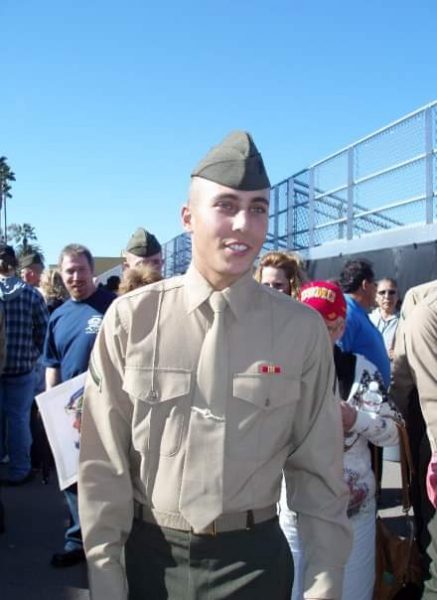 soldier (Kyle Moncrieff) with a group of people behind him