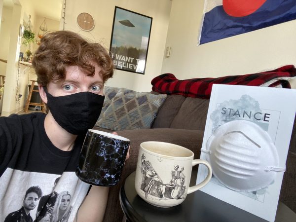 student with face mask and journal