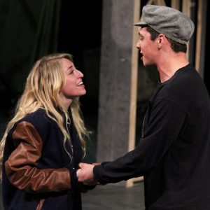 a female and male theatre student rehearse a song from the show