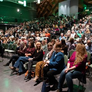 Guests sit in theater style seating at a Democracy Summit event