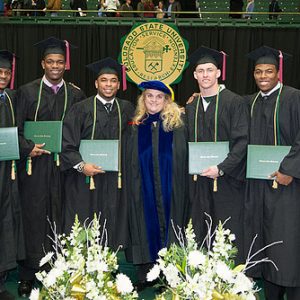 Gill congratulates student-athlete graduates at a College of Liberal Arts commencement ceremony.