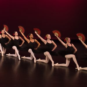 Dance students perform classical ballet repertoire poses