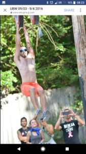 Dustin Fishman hangs from an obstacle course in preparation for the American Ninja Warrior show