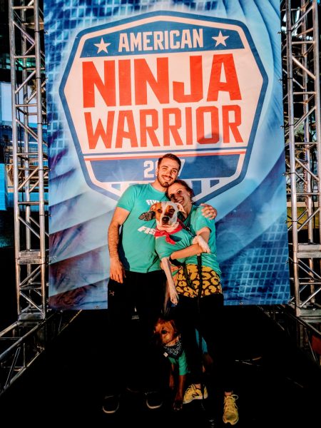 Dustin Fishman on the set of American Ninja Warrior with his fiancée and dogs