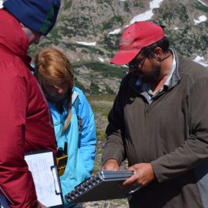 Jason LaBelle showing data to students out in the field