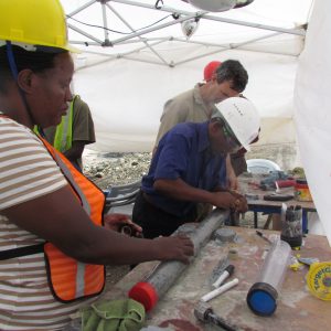 Researchers label a freshly sealed sediment core sample from Lake Magadi in Kenya