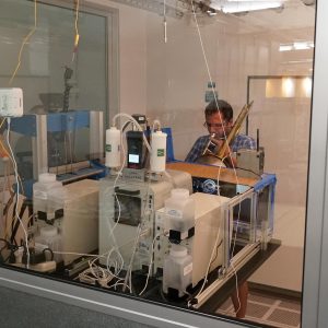 Test subject plays trombone inside aerosol chamber