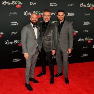 Three men at premiere of Lady Ballers