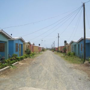 a road with small houses on each side in a rural area in Haiti