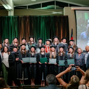 Group of DVM graduates and their Spanish professors pose for a photo at CSU Commencement in May 2026