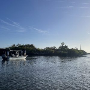 Photo of a waterway in Florida on a sunny day with a boat and island in the background