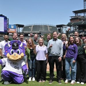 Walker Monfort and friends with Rockies mascot on baseball field