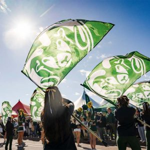 Students waving large CSU flags