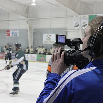 Student films a hockey match for news broadcast